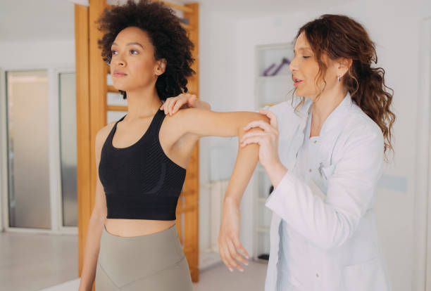 istock Female Doctor is Checking the Young Woman's Elbow 1312386000
