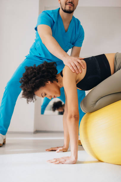 istock Young Female Doing Stretching Exercises on the Exercise Ball 1312386016