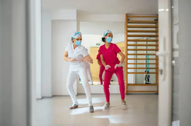 Photo of Female Nurses Dancing and Having Fun at Work