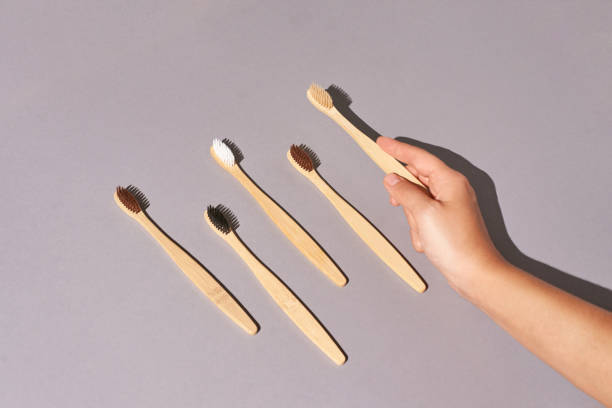 istock Hand holding toothbrush. Bamboo eco brush 1312386173