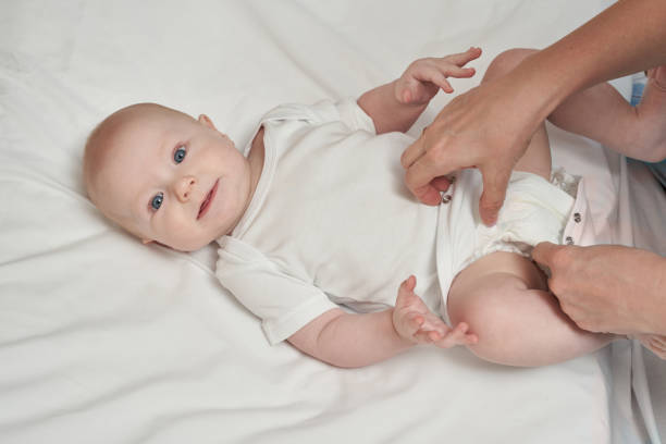 istock Cute small boy lying at bed. Childhood concept. Light background 1312386203