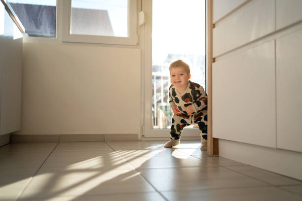 istock Cheerful Caucasian baby boy making his first steps at home 1312386290