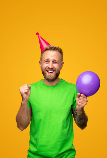 istock Optimistic male with balloon celebrating birthday 1312386391
