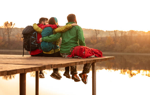 istock Unrecognizable friends hugging near lake 1312386428