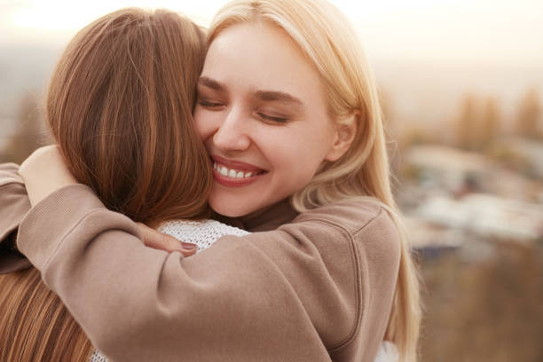 istock Happy best girlfriends hugging in nature 1312386444