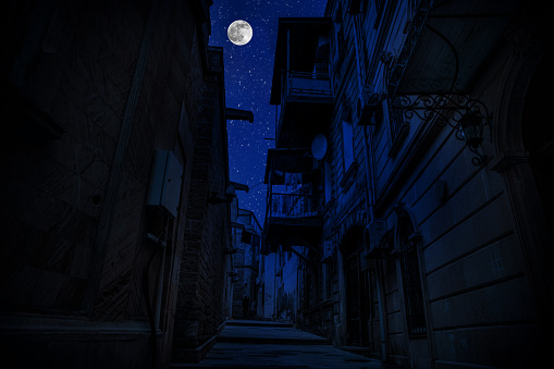 Old city streets at night. Full moon over the city at night, Baku Azerbaijan. Big full moon shining bright over buildings