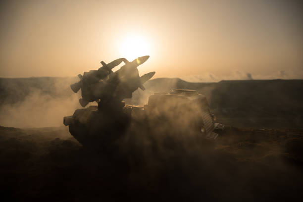 istock War concept. Battle scene with rocket launcher aimed at gloomy sky at sunset time. Rocket vehicle ready to attacSelective focus 1312386855