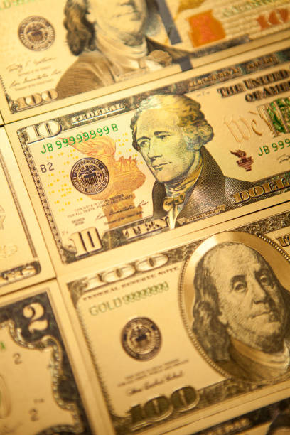 istock Currency US golden dollar banknotes close-up background. 1312390024