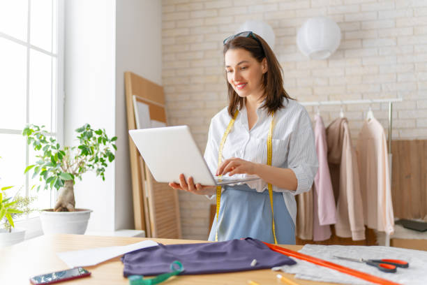 Woman is working at workshop Woman is working at workshop. Concept of small business. clothing design studio photos stock pictures, royalty-free photos & images