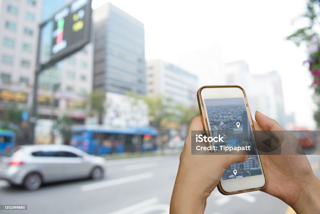 Gps map navigator on the road Hand using smart phone searching location on satellite navigation application and network connection over traffic transportation in city, internet of things, satellite navigation system app concept Map Stock Photo