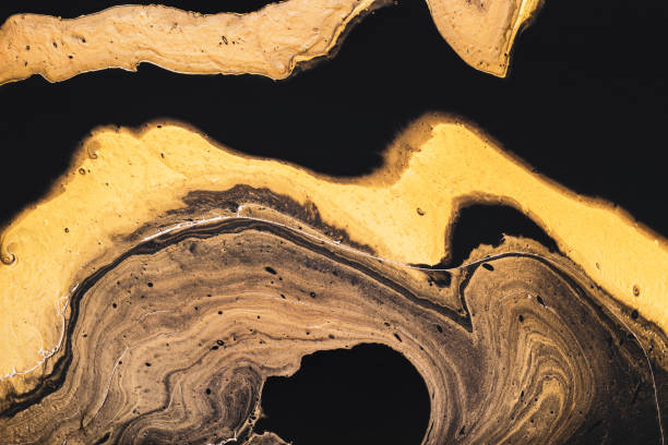 istock Golden slice of stone on black. Abstract liquid marble background or texture. Acrylic Fluid Art. Digital decor 1312401607