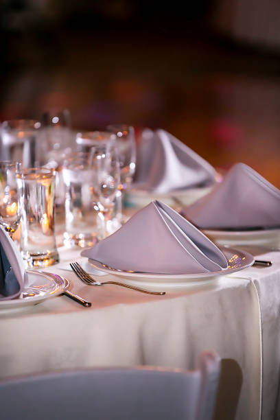 istock Indoor dinner setting for a wedding ceremony event with flowers and candles 1312402403