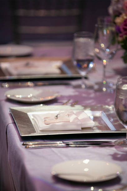 istock Indoor dinner setting for a wedding ceremony event with small gift on plate 1312402406