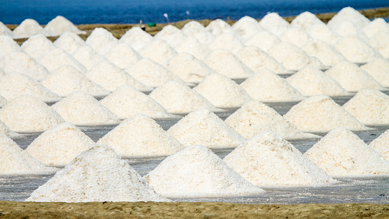 Sea salt pat, salt evaporation pond. Closeup of sea salt pile pyramid. Sea salt farming concept, in Samut Sakhon , Thailand