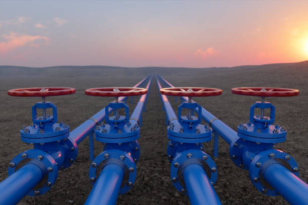 土壌と日の出の背景に青いガスまたは配管バルブを使用した石油またはガス輸送 - valve ストックフォトと画像