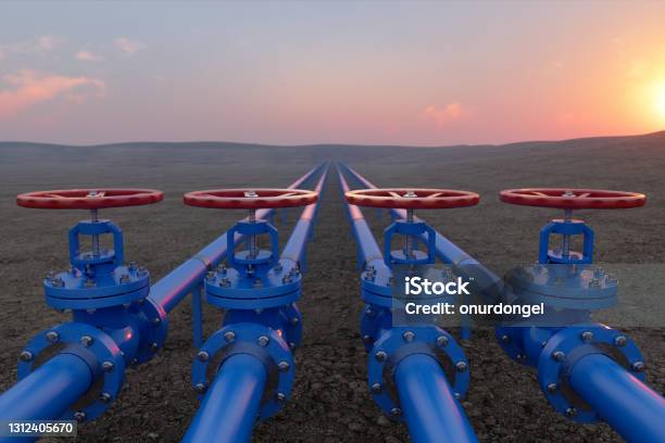 Oil Or Gas Transportation With Blue Gas Or Pipe Line Valves On Soil And Sunrise Background Stock Photo - Download Image Now