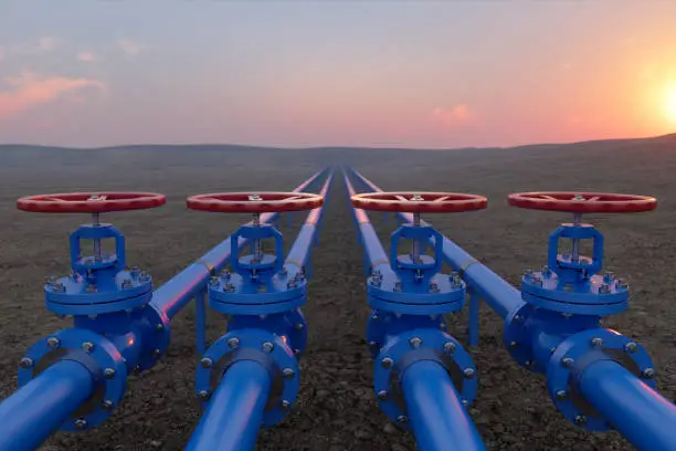 Photo of Oil Or Gas Transportation With Blue Gas Or Pipe Line Valves On Soil And Sunrise Background