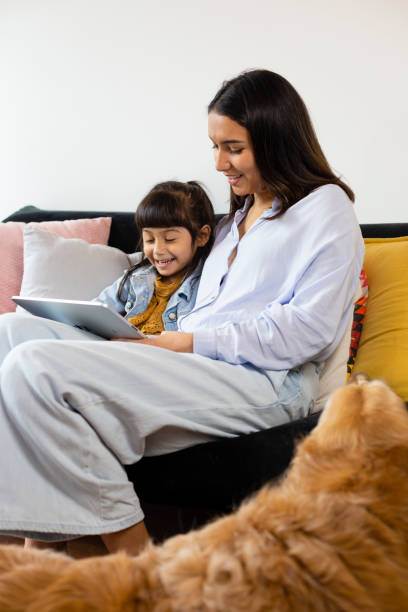 istock Young woman helping sister with homework 1312405987