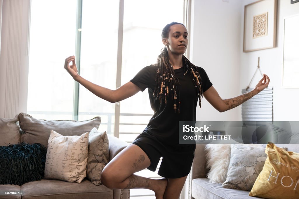 Androgynous Person Working out An androgynous person Working out at home during the Covid-19 pandemic. Non-Binary Gender Stock Photo