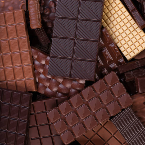 istock Organic chocolate background, pile of cocoa bars, top view. 1312410197