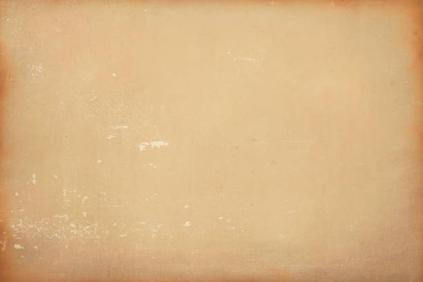 istock Texture of old light brown paper with spots and scratches. 1312411174