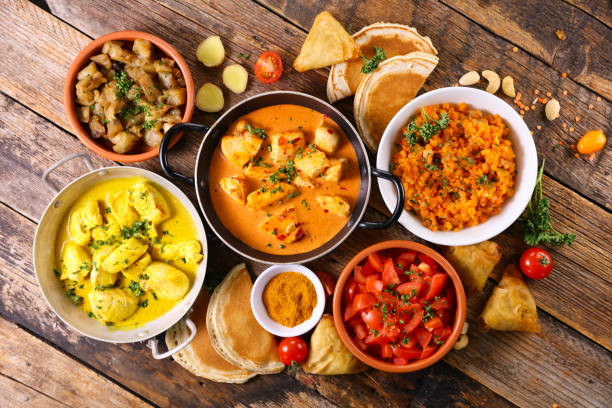 istock assorted indian food - naan, curry chicken, dhal lentil and rice 1312412311