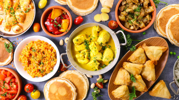 istock indian food assortment- naan, curry chicken, samosa, dhal lentils 1312412314