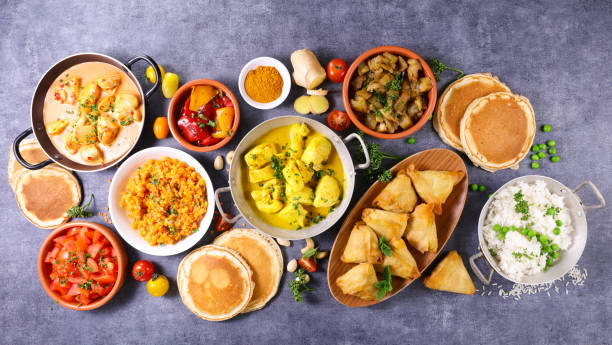 istock indian food assortment- naan, curry chicken, samosa, dhal lentils 1312412320