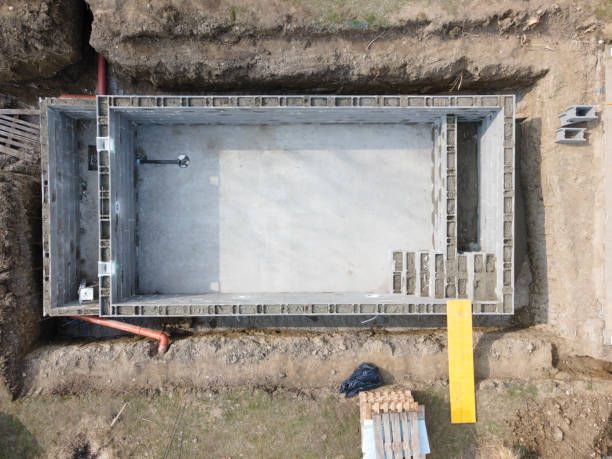 istock Drone shot of pool construction site, form blocks being filled with concrete 1312413077