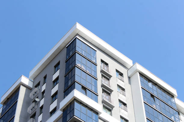 istock Corner of a new building on a blue sky background 1312415254