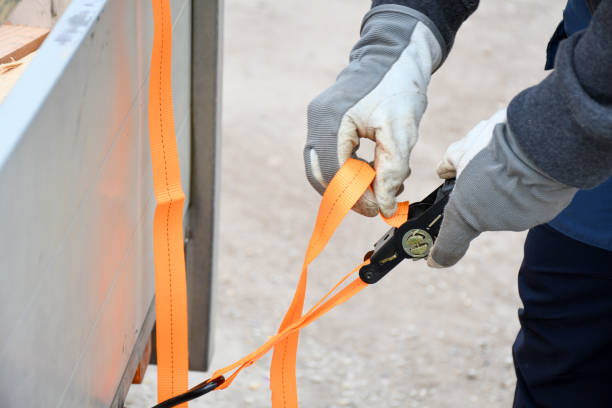Action non focus fixing trailer strop or strap in orange nylon and metal, object helping for holding stuff , storage and transport for safty and security.