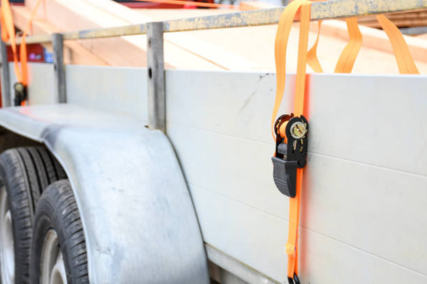 istock Trailer strop or strap in orange nylon and metal, object helping for holding stuff , storage and transport for safty and security. 1312416512