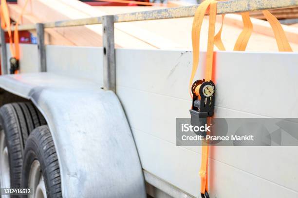 Trailer Strop Or Strap In Orange Nylon And Metal Object Helping For Holding Stuff Storage And Transport For Safty And Security Stock Photo - Download Image Now