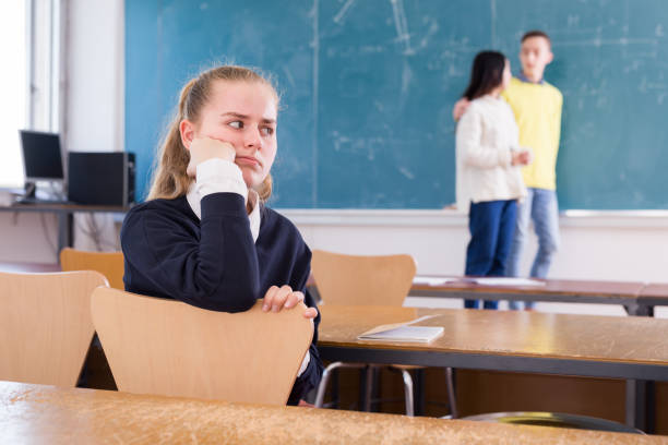 istock Unhappy girl sitting in class 1312416652