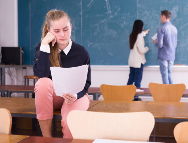 istock Young sad girl preparing for the exam in classroom 1312416670
