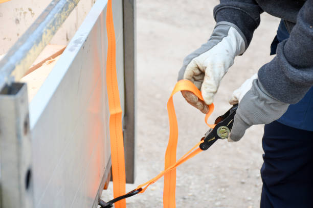 istock Action non focus fixing trailer strop or strap in orange nylon and metal, object helping for holding stuff , storage and transport for safty and security. 1312416690