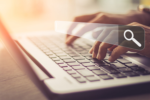 Businesswoman using laptop searching Browsing Internet Data Information