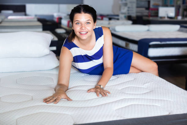 istock Female is lying on mattress for testing it in the store. 1312418681