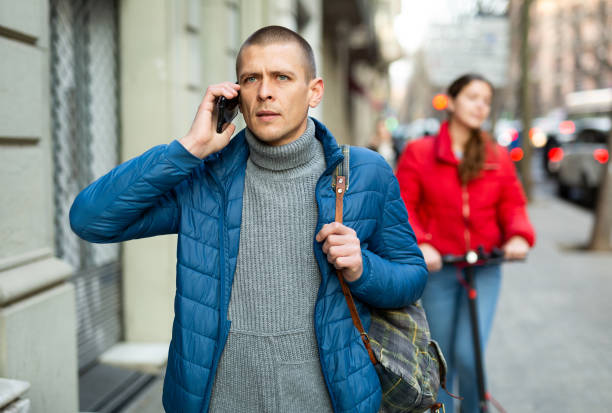 istock Man in blue jacket talking on mobyle phone 1312419383