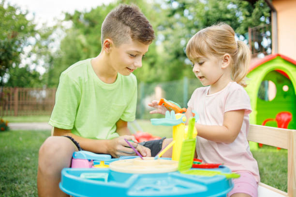 istock Young girl playing outdoors with her older brother 1312419418