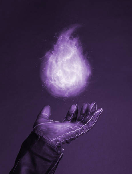 Levitating magic fire flame on a special glove - Concept of magic stock photo