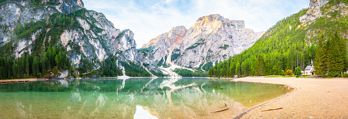 Beautiful sunrise panorama at Lago di Braies lake in Italy Dolomites. Mountains Alps in the background tyrol Landscape. Forest and Nature.