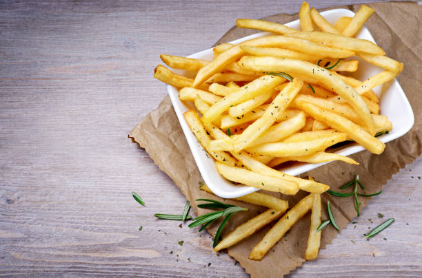 istock French fries, Chips on wooden background. Top view, space for text. 1312420411