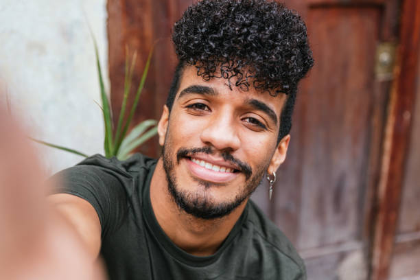 Selfie of a hispanic young man smiling to camera