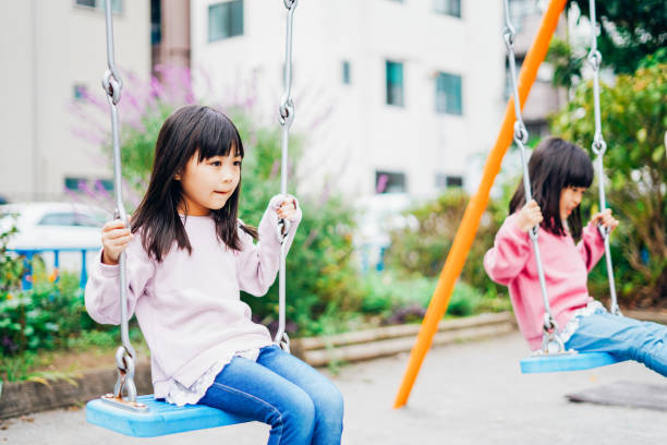 istock Two girls playing happily in the park 1312423215