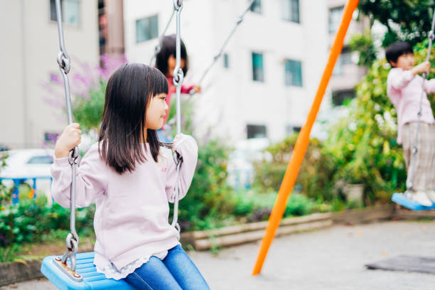 istock Two girls playing happily in the park 1312423219