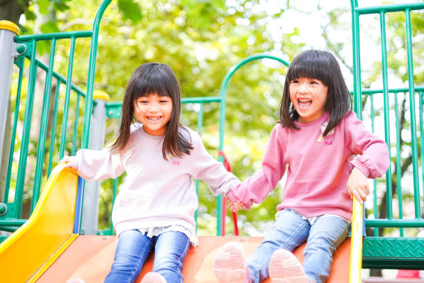 istock Two girls playing happily in the park 1312423249