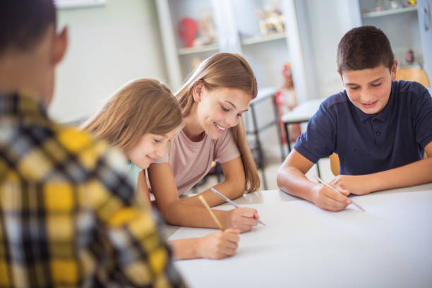 istock Teenagers students sitting in the classroom and talking. 1312423474