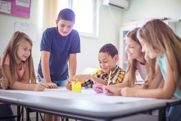 istock Multi-ethnic school children discussing in classroom. 1312423530