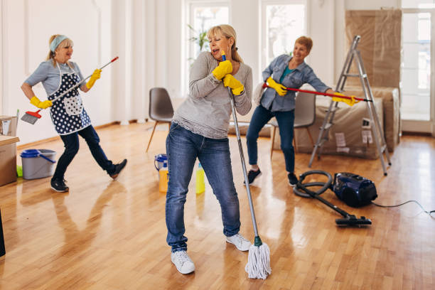 istock Female cleaners singing and dancing 1312424454